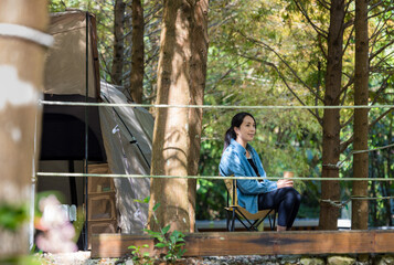 Wall Mural - Asian woman go camping inside the forest