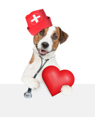 Sticker - Clever jack russell terrier wearing like a doctor with stethoscope on his neck looks above empty white banner and holds red heart. isolated on white background