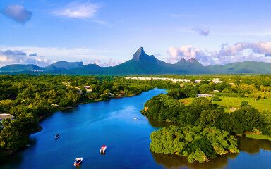 fishing boats resting at Tamarin Bay Mauritius island Indian Ocean Africa with Tamarin Mountain on the background at sunset. Tamarin Lagoon Mauritius