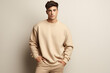 © Elena - Male young model in beige blank sweatshirt, sweater on beige background. Clothes mockup. AI Generative