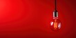 Light bulb on red background