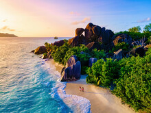 Anse Source D'Argent Beach, La Digue Island, Seyshelles, Drone Aerial View Of La Digue Seychelles Bird Eye View.of Tropical Island, Couple Men And Woman Walking At The Beach During Sunset At A Luxury