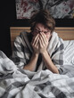 © Rajko - Sick Man in Bed Feeling Miserable during Flu Season Covid or Common Cold