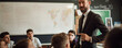 Male teacher is teaching pupils in the classroom