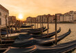 Venice gondolas in Italy with spectacular romantic sunset over the waters of the Lagoon canal