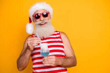 Poster - Photo of excited funky elderly guy wear new year swimsuit hat sunglass enjoying alcohol cocktail empty space isolated yellow color background