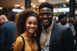 Young black professionals man and woman standing at a networking reception in business and gala event.