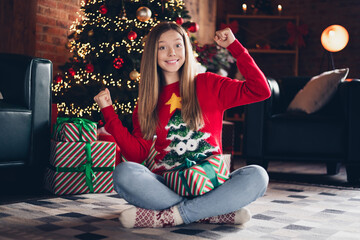 Poster - Full size photo of overjoyed schoolgirl with blond hairstyle wear red sweater sit on floor get present celebrate new year at home indoors