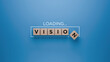 Wooden blocks spelling 'VISION' with a loading progress bar on a blue background, strategic planning and foresight concept