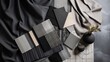 Elegant flat lay composition in grey and black color palette with textile and paint samples, lamella panels and tiles. Architect and interior designer moodboard. Top view. Copy space.