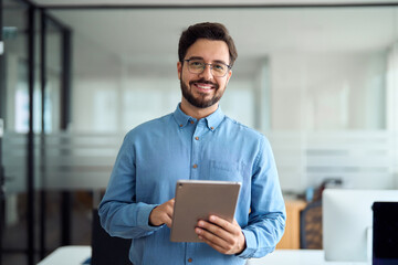 smiling busy young latin business man manager using tablet computer, happy hispanic businessman exec