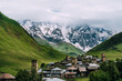 Panoramic view of medieval towers and Shkhara peak in village Ushguli in the Caucasus Mountains, Georgia.Stone towers and ancient houses in Ushguli, Georgia. UNESCO site, popular tourist destination.