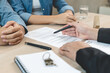 © Pormezz - Hand of broker showing to client where to sign signature contract.