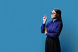 © Valerii Honcharuk - Profile view, portrait of serious young woman in on blue background, copy space