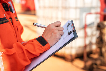 Wall Mural - action of safety officer is writing and check on checklist document during safety audit and inspecti
