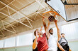 © Marko Geber - Young people playing basketball in an indoor basketball gym