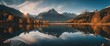 A captivating view of a mirror-like lake reflecting the perfect symmetry of the mountains above