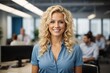 © kapros76 - Smiling attractive curly blonde confident professional swedish woman posing at her business office with her coworkers and employees in the background.