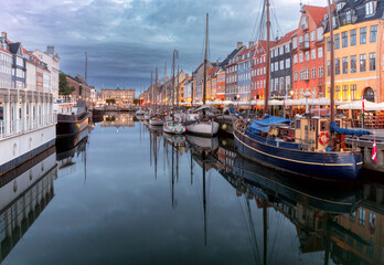 Wall Mural - Copenhagen. Nyhavn canal colorful traditional houses and city embankment at sunrise.