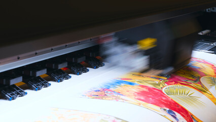 Poster - A moving working industrial wide format printer prints a color picture on paper.