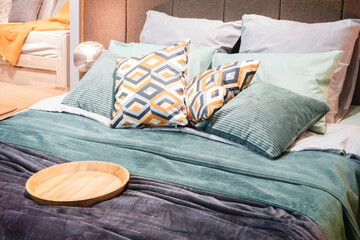 Poster - Interior of a modern bedroom in an apartment, hotel or private house with a bed and pillows