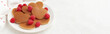 © Darya Lavinskaya - A heap of heart shaped pancakes with raspberries on the white plate on the white background