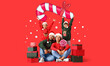 canvas print picture - Happy family in Santa hats, with Christmas gifts and candies on red background