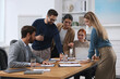 © New Africa - Team of employees working together in office