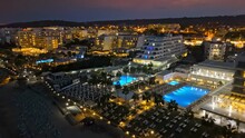 Aerial Night View Of Luxury Hotels And Resorts In Protaras, Cyprus. Beachfront Resorts On Mediterranean Sea. Nightlife In Summer Cyprus 
