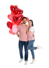 Sticker - Happy young couple with heart shaped balloons isolated on white. Valentine's day celebration