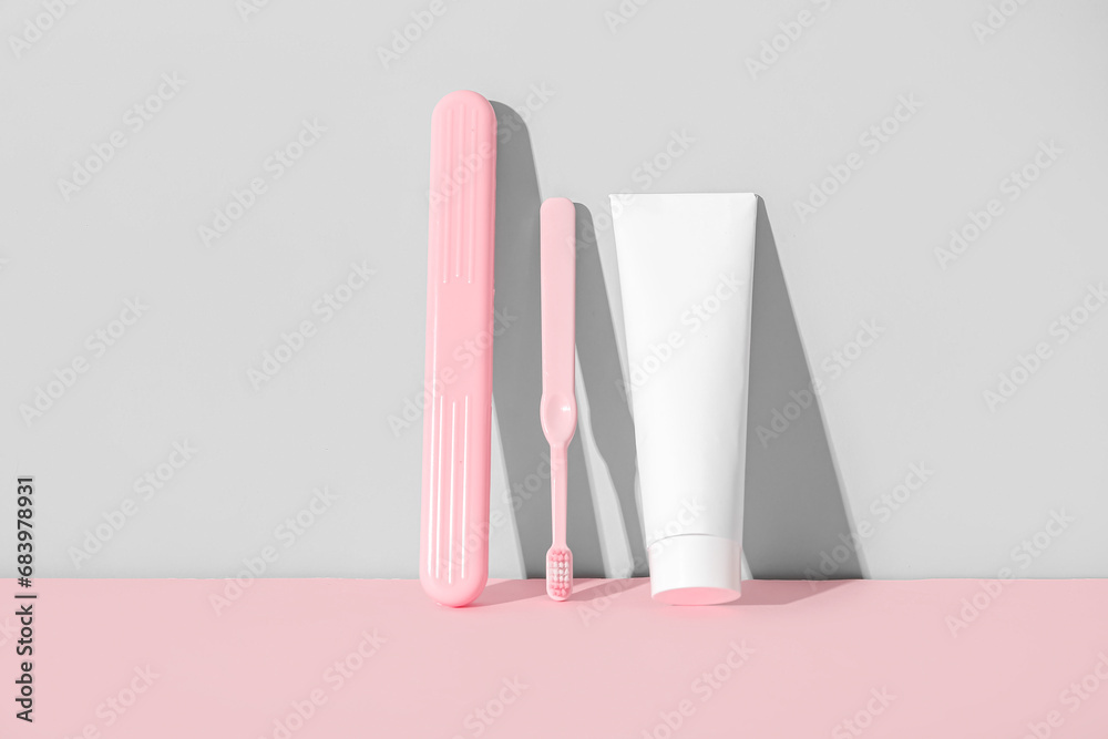 Toothbrush with toothpaste and case on color background.