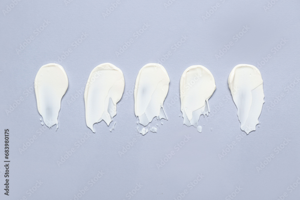 Smears of cream on grey background