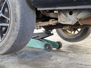 Wall Mural - old Vehicle and the floor Jack Lift vehicle servicing and maintenance