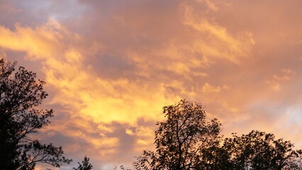 Wall Mural - the beautiful sunset view with the colorful clouds and warm sunlight