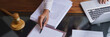 © Pichsakul - Lawyer woman working to typing data on laptop while checking legal agreement of business contract