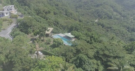 Sticker - Drone shot of a house with a pool on a green forested hill