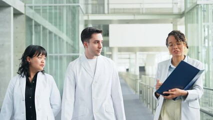 Poster - A multinational group having a conversation in the lobby.
People in white coats and sales staff. High angle view.