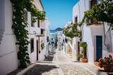 Fototapeta Uliczki - Charming narrow street with white buildings and colorful flowers in a quaint village setting. Generative AI