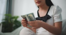 Footage Of Happy Young Asian Woman Counts Cash Dollar Bills While Sitting In Living Room At Home,counting Stack Cash Money Dollar