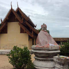 old buddha sculpture in a monastery area in northern thailand