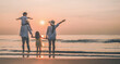 © Garun Studios - Happy asian family that enjoys beach activities during the summer holidays.