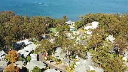 Wall Mural - Raffertys resort in Murrays beach on Lake Macquarie – aerial over roofs fly 4k.
