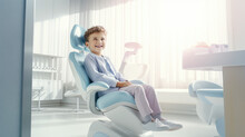 Сute Healthy Smiling Child Sits In A Modern Dentist Chair Of Kids Dentistry Clinic. Dentist For Children, Modern Dental Clinic.