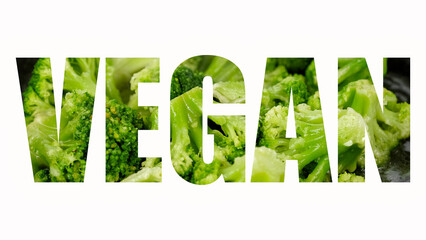 Wall Mural - A word Vegan on white background. Fresh broccoli frying on a pan in sign - Vegan