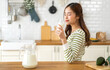 © Art_Photo - Portrait of beauty healthy asian woman smiling and having protein breakfast drinking and hold glasses of milk of fresh milk, nutrition,calcium and vitamin,dairy product in kitchen at home.Diet concept