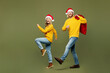 © ViDi Studio - Full body side view merry young couple two friends man woman wear sweater Santa hat posing hold shopping bags isolated on plain light green background. Happy New Year Christmas sale buy day concept.