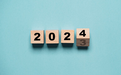 Wall Mural - flipping of 2023 to 2024 on wooden block cube for preparation new year change and start new business