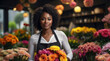 Smiling friendly african american young female florist working in the market. girl, modern flower shop. tulips for Women's Day March 8th. banner