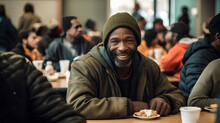 A Positive Homeless Man, Sitting At A Table In A Charity Canteen.