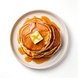 Top view of pancakes with butter and honey on white background.